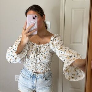 Flowery, long sleeve white top.